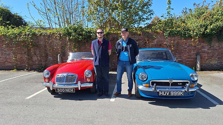 Hamish McNaught (left) pictured with his MGA car and his dad Kenneth McNaught (right) pictured with his MG B GT insured with MG Car Club Insurance